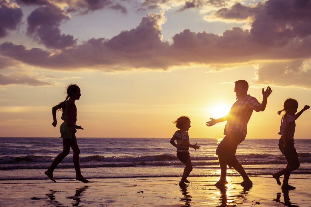 family playing on the beach