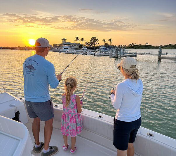 mom-dad-and-daughter-fishing-off-boat-at-port-sanibel-marina
